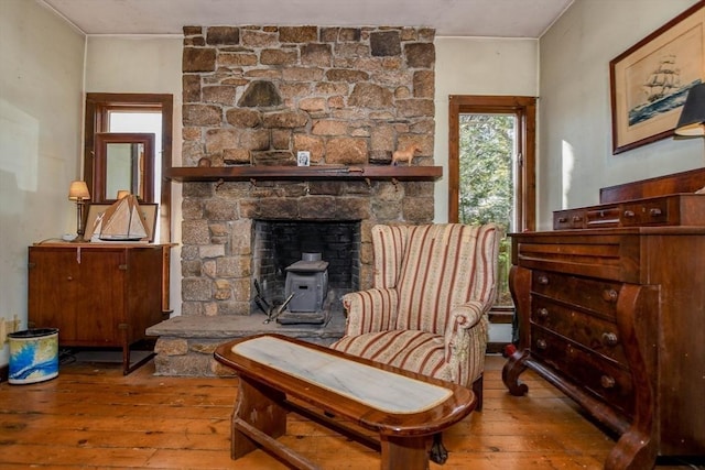 sitting room with light wood-style flooring and a fireplace