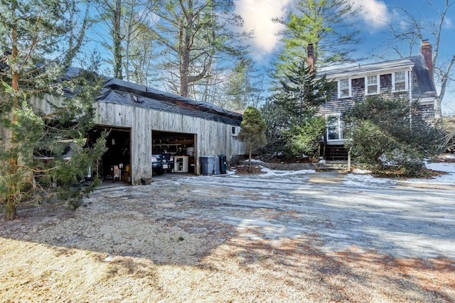 exterior space with a garage and an outdoor structure