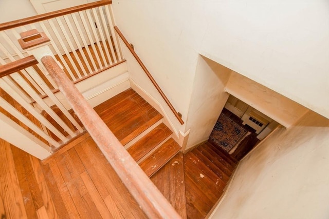 stairway featuring wood finished floors