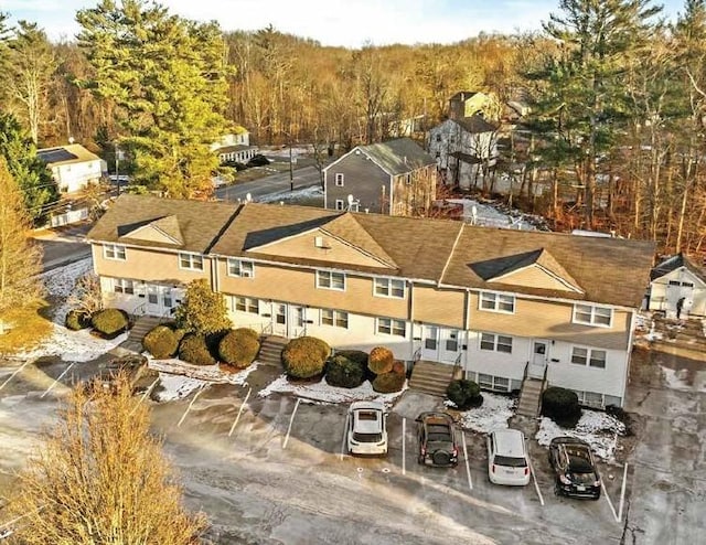 birds eye view of property with a wooded view