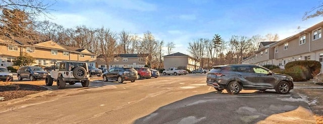 uncovered parking lot with a residential view