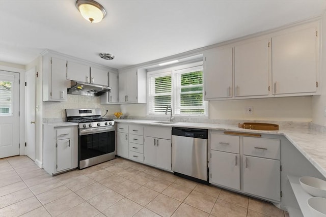 90 Woodland Rd, Malden, MA 02148 - kitchen featuring appliances with stainless steel finishes, under cabinet range hood, light countertops, and light tile patterned flooring