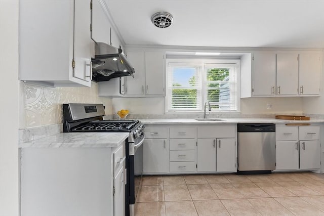 90 Woodland Rd, Malden, MA 02148 - kitchen with stainless steel appliances, under cabinet range hood, a sink, light countertops, and light tile patterned flooring