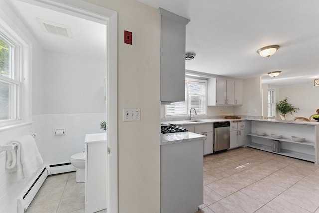 90 Woodland Rd, Malden, MA 02148 - kitchen featuring stainless steel dishwasher, a sink, light tile patterned flooring, light countertops, and a baseboard radiator