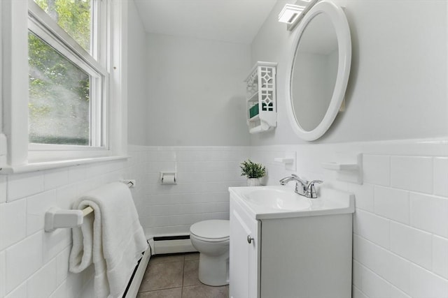 90 Woodland Rd, Malden, MA 02148 - half bathroom with tile walls, tile patterned floors, vanity, toilet, and wainscoting