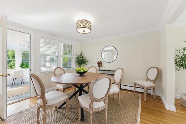 90 Woodland Rd, Malden, MA 02148 - dining space featuring a baseboard radiator, light wood finished floors, ornamental molding, and baseboards