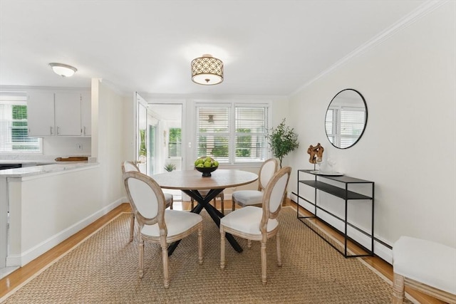 90 Woodland Rd, Malden, MA 02148 - dining room featuring light wood-style flooring, baseboards, ornamental molding, and a baseboard radiator