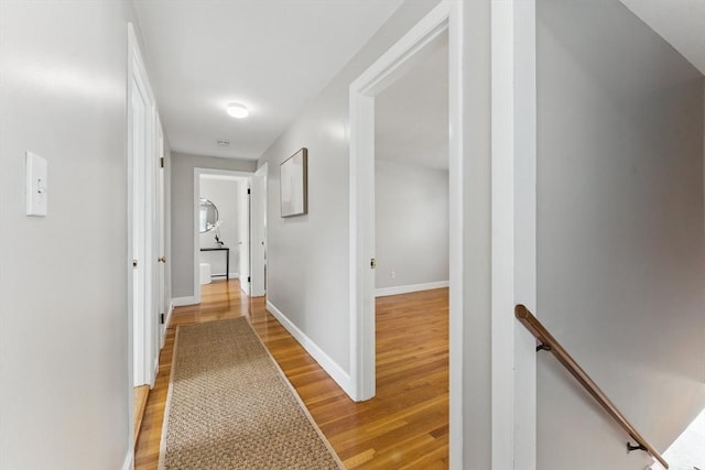 90 Woodland Rd, Malden, MA 02148 - corridor with an upstairs landing, light wood finished floors, and baseboards