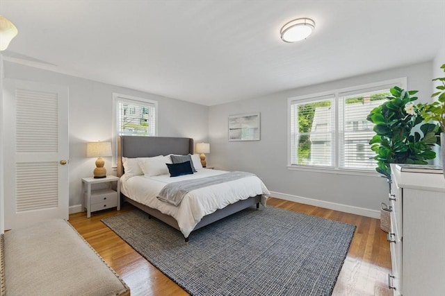 90 Woodland Rd, Malden, MA 02148 - bedroom with multiple windows, light wood-style floors, and baseboards