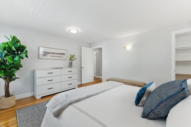 90 Woodland Rd, Malden, MA 02148 - bedroom featuring light wood-style flooring, baseboards, and a spacious closet