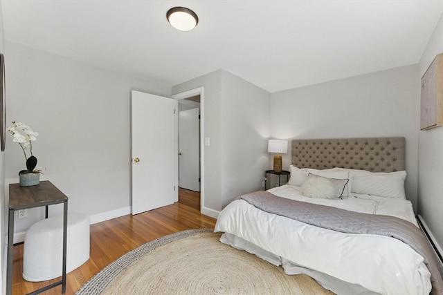 90 Woodland Rd, Malden, MA 02148 - bedroom featuring wood finished floors, baseboard heating, and baseboards