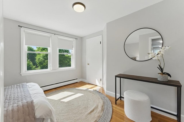 90 Woodland Rd, Malden, MA 02148 - bedroom featuring a baseboard radiator, wood finished floors, and baseboards