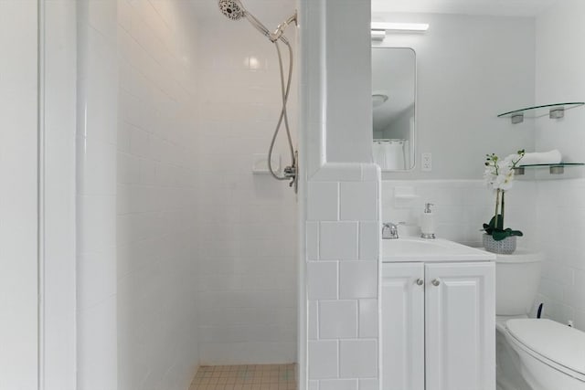 90 Woodland Rd, Malden, MA 02148 - bathroom featuring vanity, a tile shower, tile walls, toilet, and a wainscoted wall