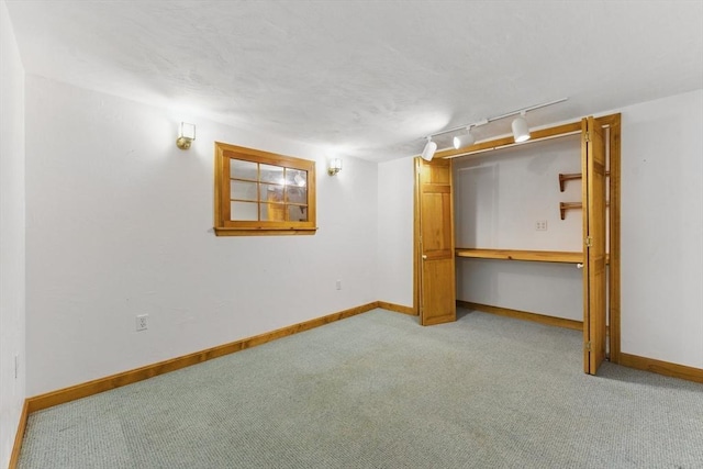 90 Woodland Rd, Malden, MA 02148 - unfurnished bedroom with rail lighting, light carpet, baseboards, and a closet