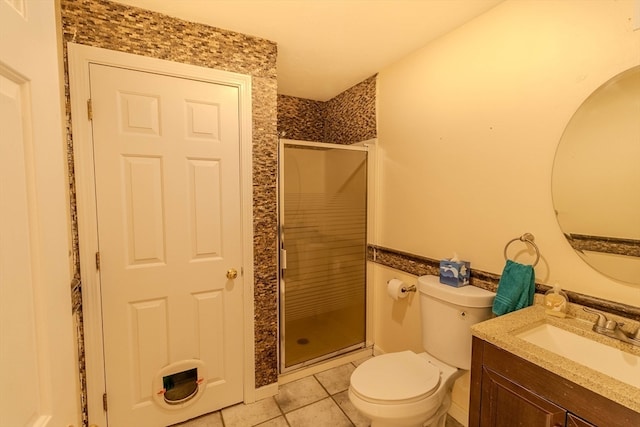 bathroom featuring toilet, vanity, an enclosed shower, and tile patterned flooring