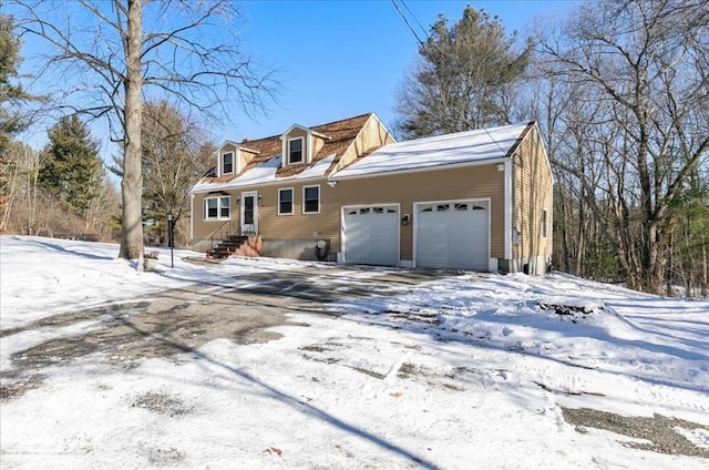 cape cod home featuring a garage