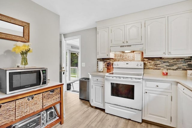 389 Porter Rd, East Longmeadow, MA 01028 - kitchen featuring white appliances, under cabinet range hood, tasteful backsplash, and light wood-style floors