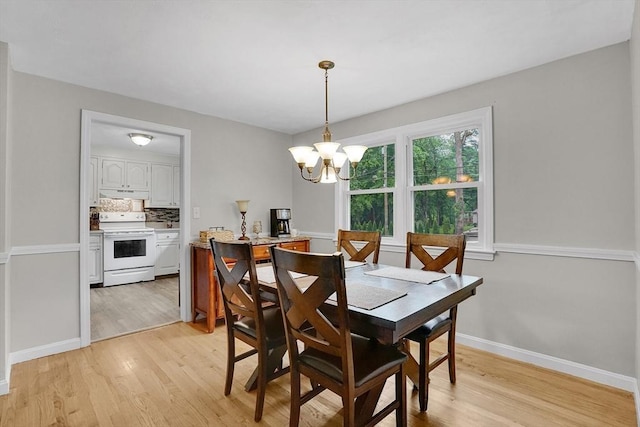389 Porter Rd, East Longmeadow, MA 01028 - dining space with light wood finished floors and a chandelier