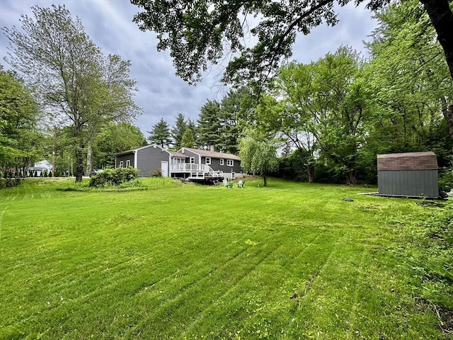 389 Porter Rd, East Longmeadow, MA 01028 - view of grassy yard with a shed and a deck