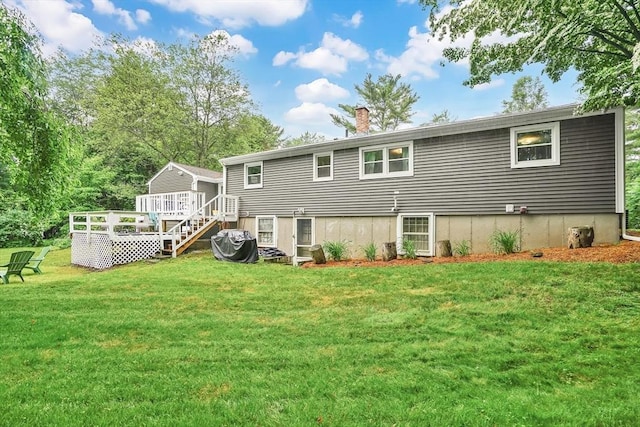 389 Porter Rd, East Longmeadow, MA 01028 - rear view of property featuring a wooden deck, a chimney, and a lawn