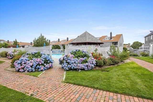 view of pool with a yard