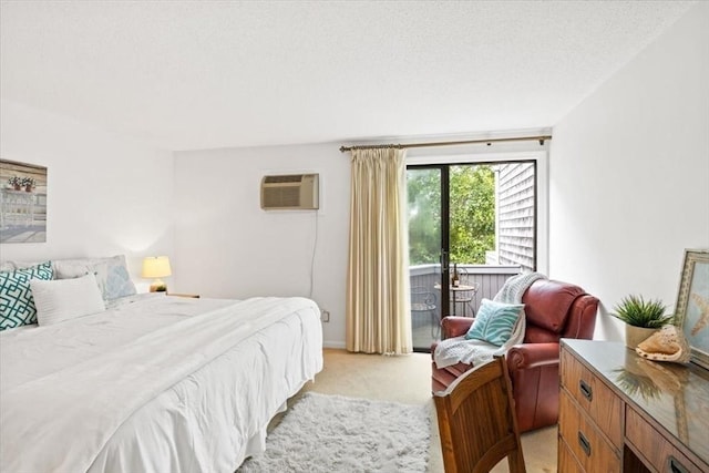 bedroom featuring a textured ceiling, light colored carpet, and a wall mounted AC