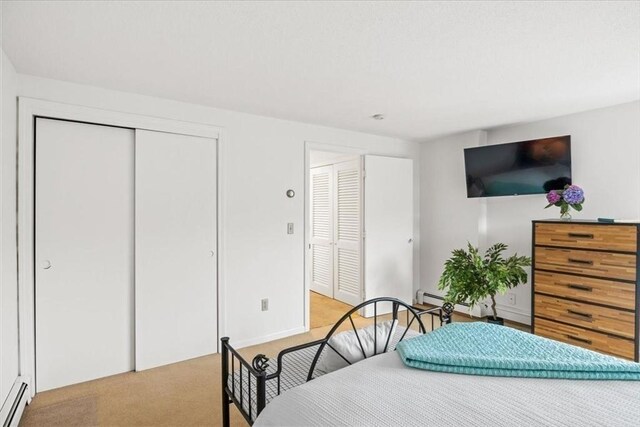 carpeted bedroom with a baseboard radiator