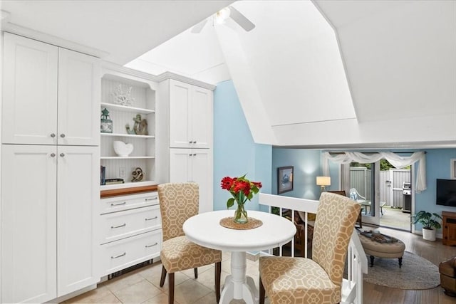 tiled dining area featuring lofted ceiling