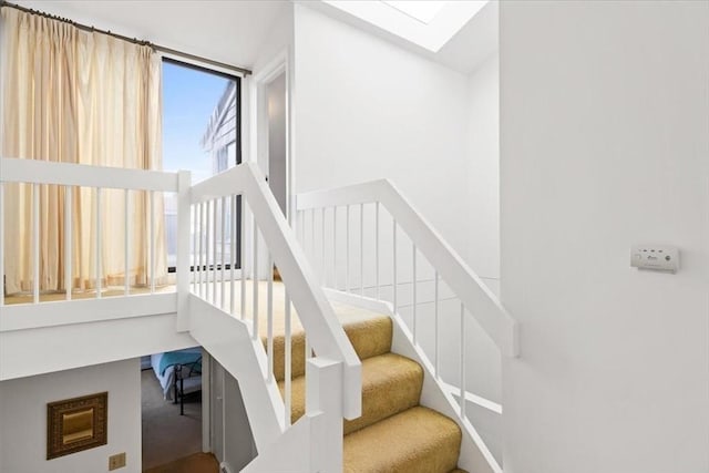 staircase featuring a skylight