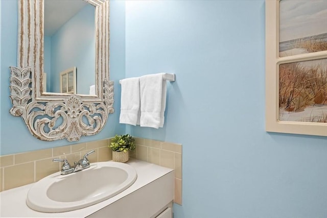 bathroom featuring vanity and backsplash