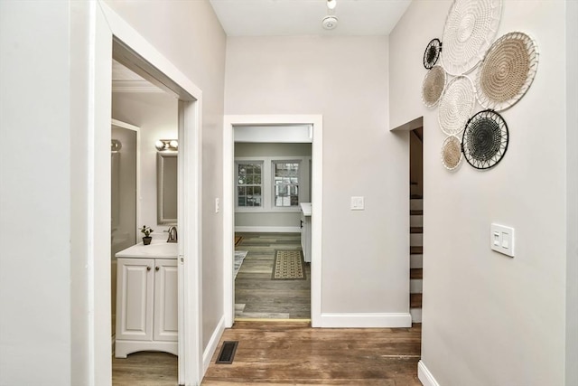 hall featuring dark hardwood / wood-style flooring and sink