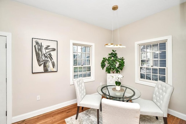 dining space with hardwood / wood-style flooring