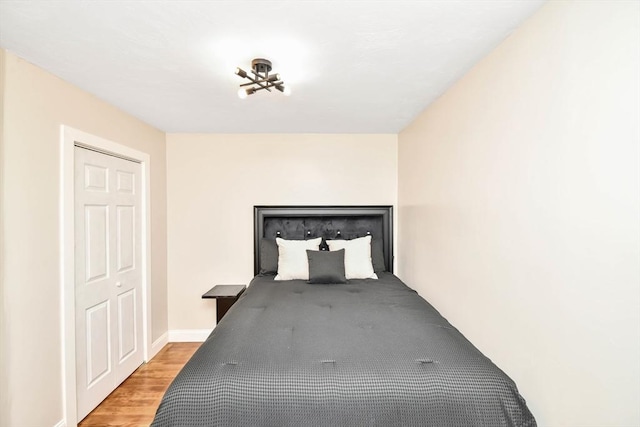 unfurnished bedroom with a closet and light wood-type flooring