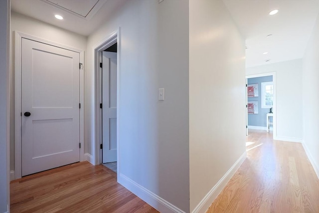 corridor with light hardwood / wood-style flooring