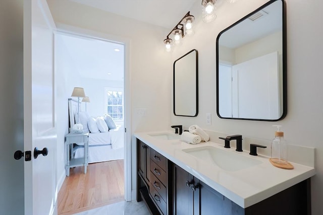 bathroom with hardwood / wood-style floors and vanity