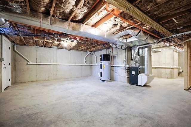 basement featuring heating unit and hybrid water heater