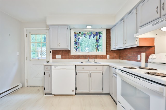 kitchen with decorative backsplash, white appliances, light hardwood / wood-style flooring, sink, and a baseboard heating unit