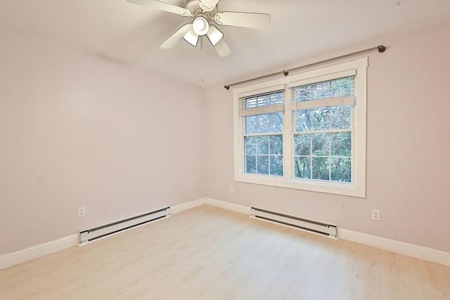 spare room featuring ceiling fan, baseboard heating, and light wood-type flooring