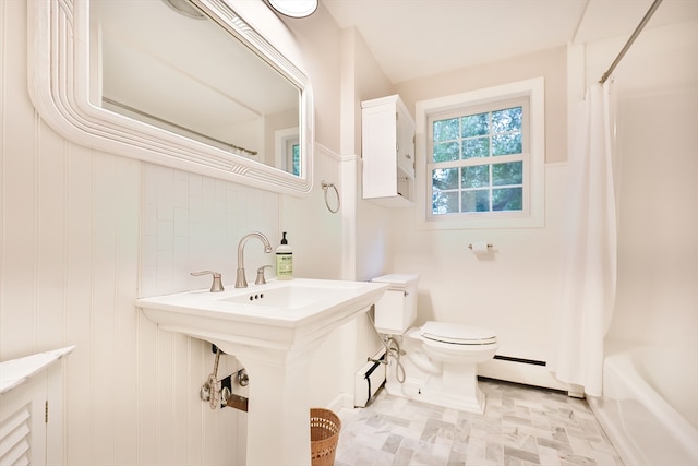 bathroom featuring shower / bath combo with shower curtain, baseboard heating, and toilet