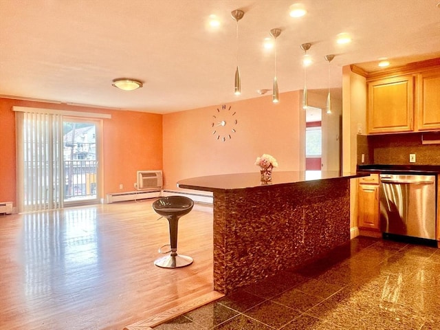 kitchen featuring a baseboard heating unit, light brown cabinetry, stainless steel dishwasher, and tasteful backsplash