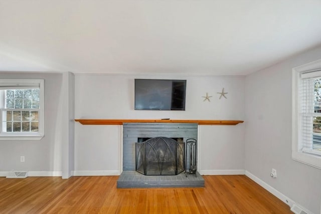 unfurnished living room with a fireplace and hardwood / wood-style flooring