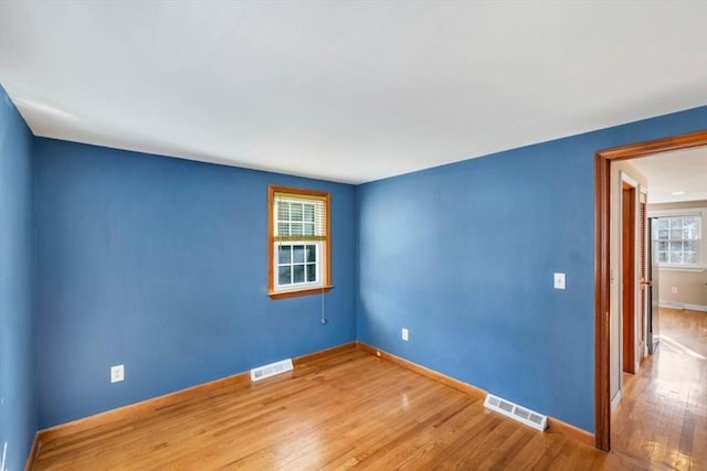 spare room with hardwood / wood-style flooring