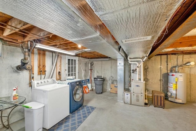 basement featuring washing machine and dryer and water heater