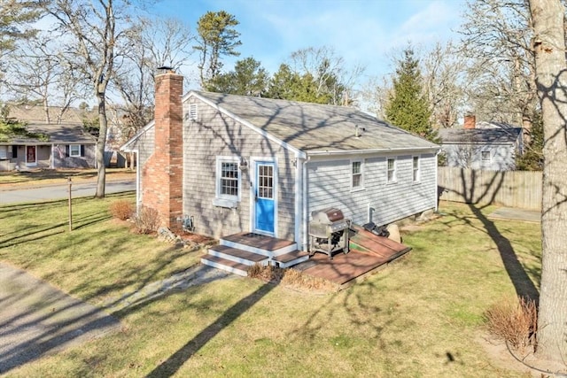 rear view of house with a yard