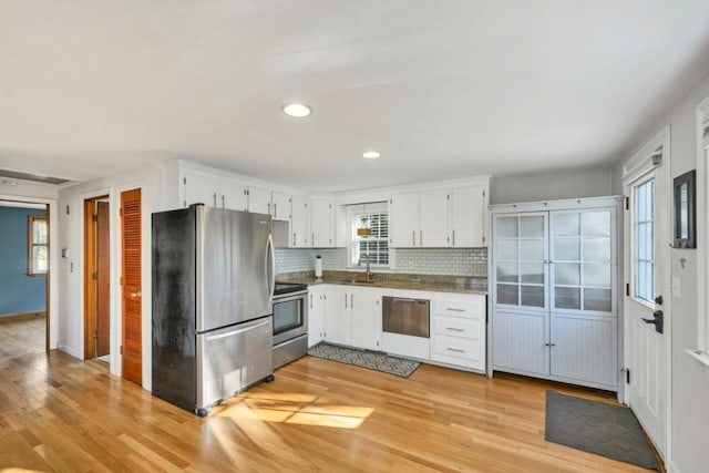 kitchen with a healthy amount of sunlight, sink, appliances with stainless steel finishes, and tasteful backsplash