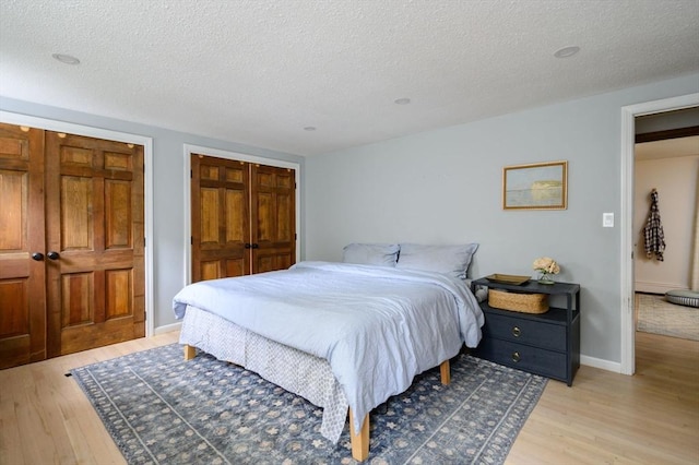 11 Williamsburg Ln, Scituate, MA 02066 - bedroom with light wood finished floors and a textured ceiling