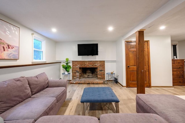 11 Williamsburg Ln, Scituate, MA 02066 - living area with light wood-style flooring, recessed lighting, and a brick fireplace