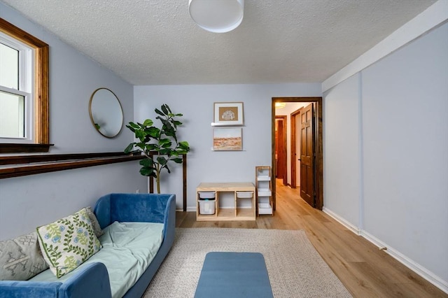 11 Williamsburg Ln, Scituate, MA 02066 - living room with a textured ceiling and wood finished floors