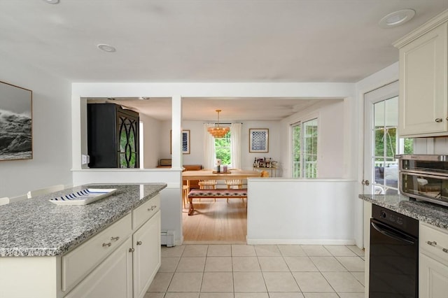 11 Williamsburg Ln, Scituate, MA 02066 - kitchen with light tile patterned flooring, light stone counters, a chandelier, a baseboard radiator, and white cabinets