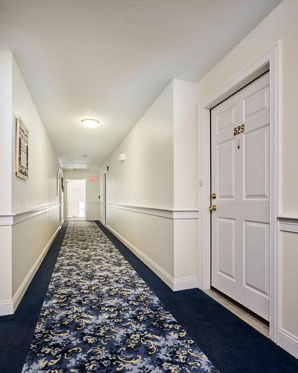 hall featuring baseboards